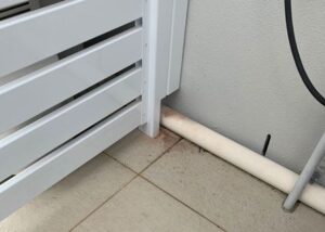 Pool pump cover for pipes out the slide